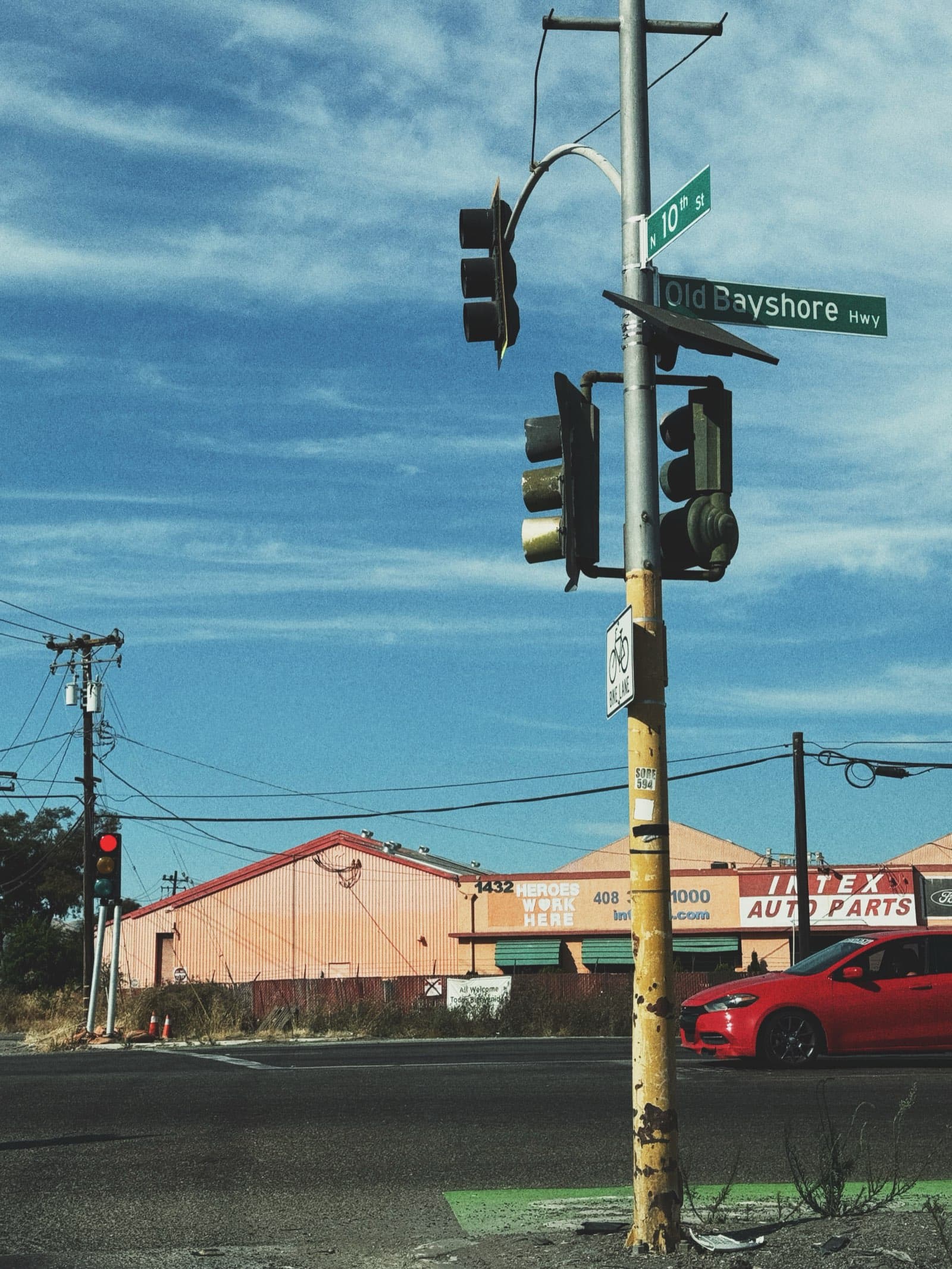 Street intersection at Old Bayshore Highway under blue sky